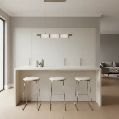Sleek backless bar stools tucked neatly under a modern kitchen island, highlighting space-saving design.