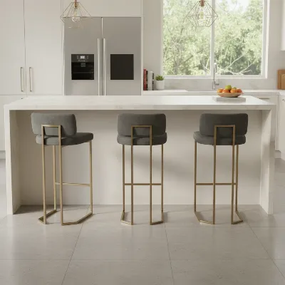 A clean, modern kitchen island with three perfectly spaced bar stools, showcasing adequate room between each for comfortable seating.