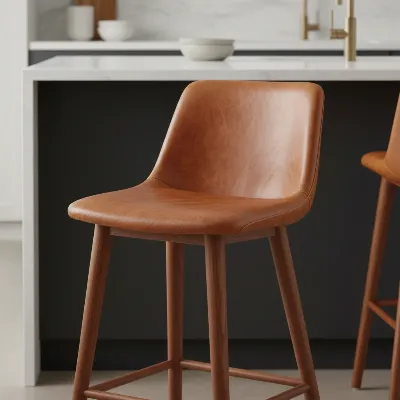 West Elm Mid-Century Leather Bar Stool in a stylish kitchen setting, highlighting its rich leather and solid wood legs.